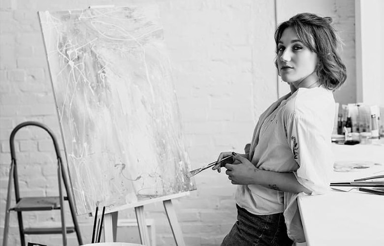 Woman doing artwork on an easel