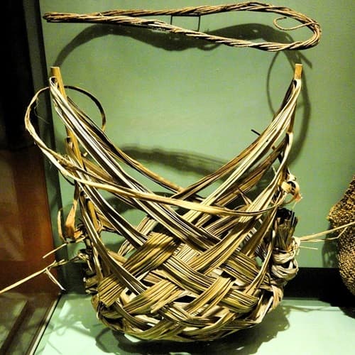 basket made from palm fronds sitting on a table