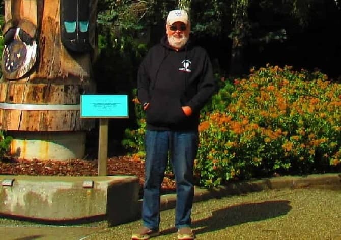 Bill is an associate at Mission: Palm Trees man standing by totem