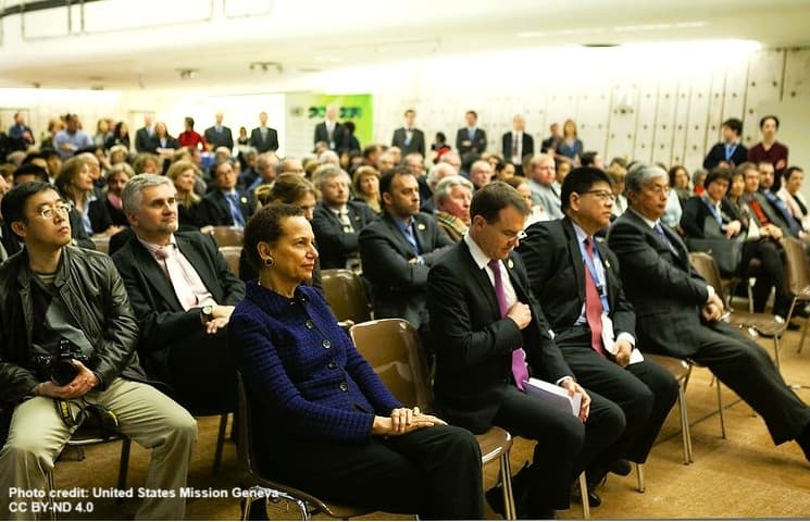 People in seating to attend the exhibit that featured photographs of species protected under CITES.