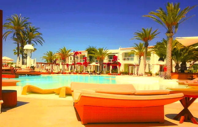 Hotel with welcoming date palm trees.