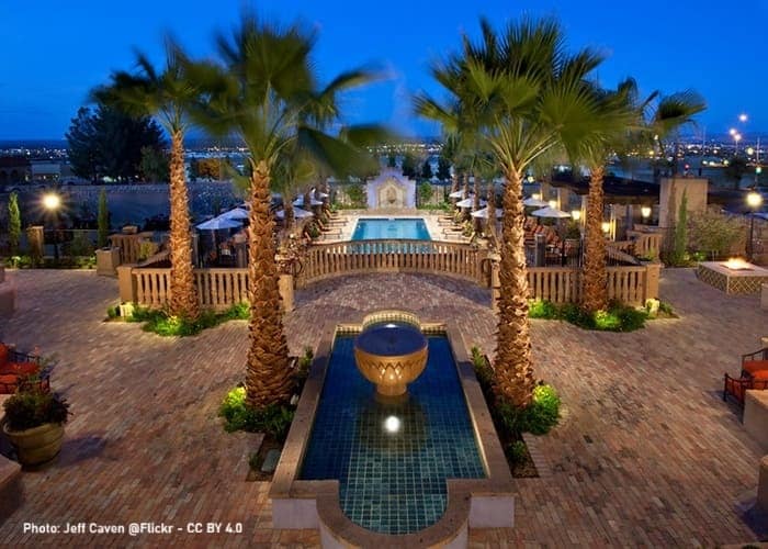 a pool with a beautiful arrangements of palm and other decor