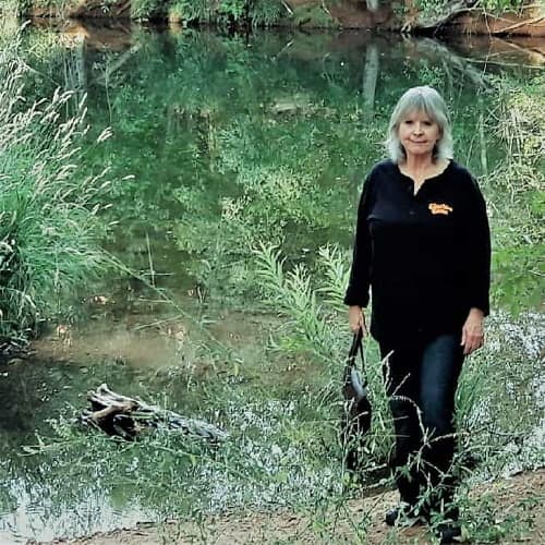 Karen is the website proprietor for Mission: Palm Trees woman at a Creekside