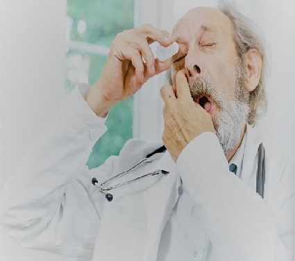 older man using eye drops