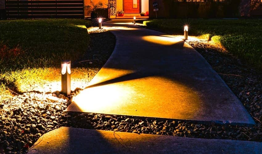 Outdoor bollard lights along the front walkway to a home