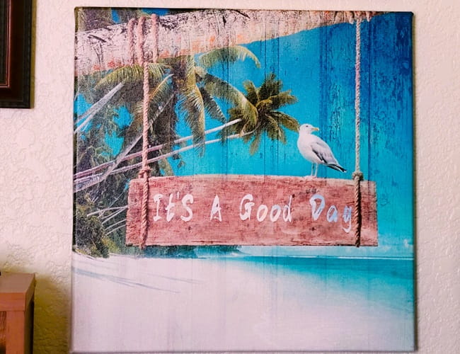 Palm tree canvas art with a beach scene telling you it's a good day.
