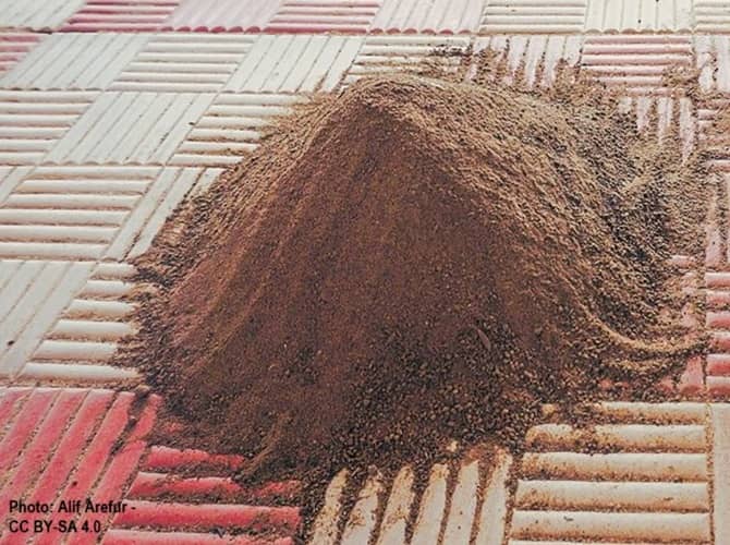 Small pile of loam type soil on a tile surface Small pile of loam type soil on a tile surface