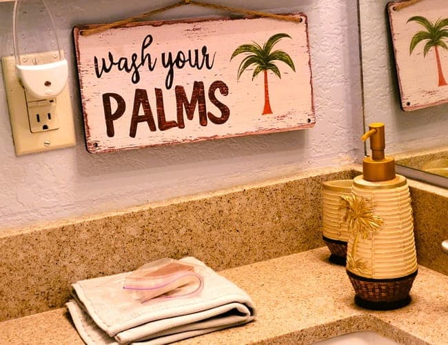 Sign on a bathroom wall by the sink asking people to wash their palms.