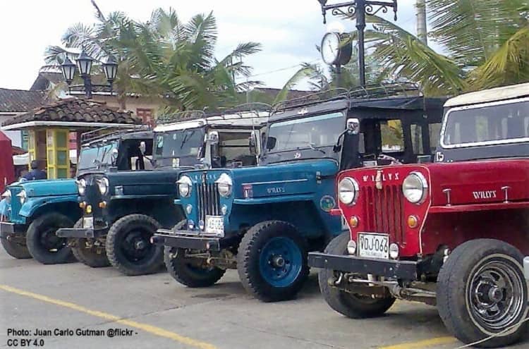 Willy's Jeeps are Columbia's common public transport. These are ready to go in Solento. Jeeps lined up in a small Columbian town
