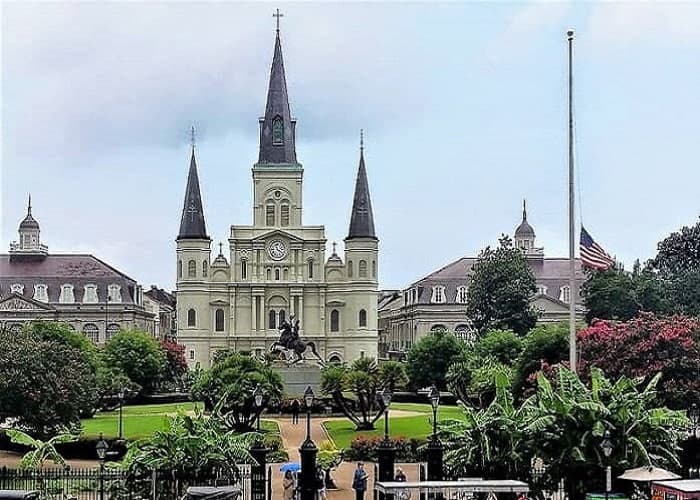 New Orleans building with palms around the grounds.