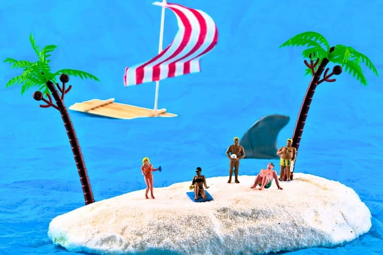 beach scene using miniature figures, palms and a raft
