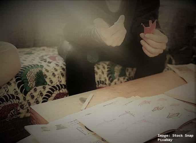 Someone working on an origami project